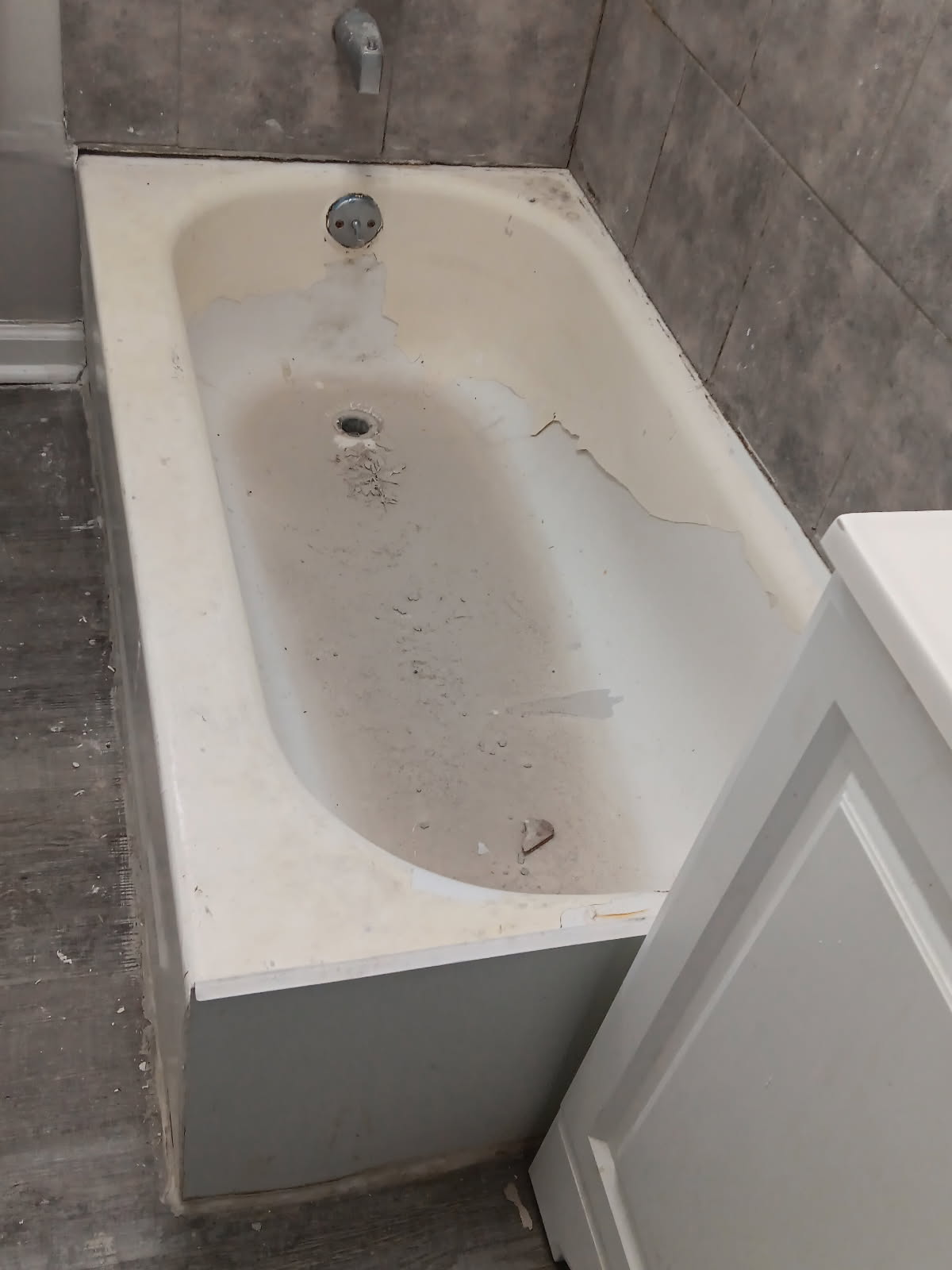 Peeling worn bathtub before refinishing