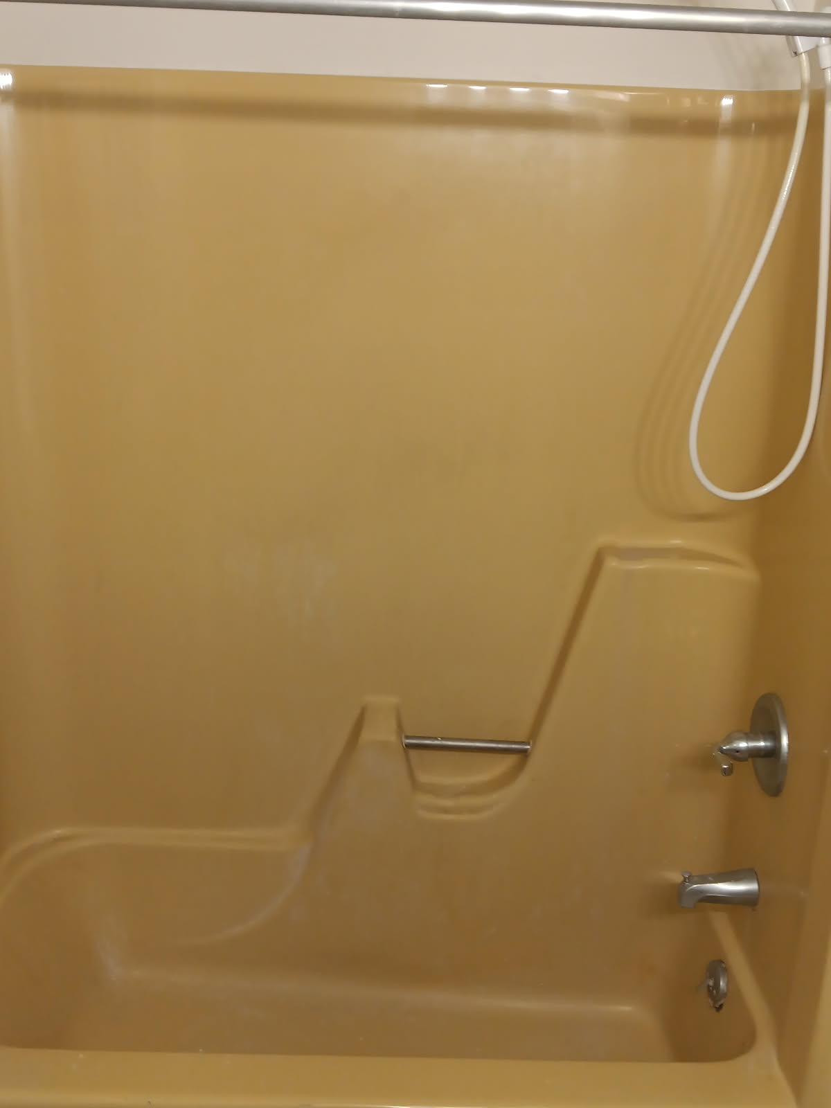 Harvest gold fiberglass shower before refinishing